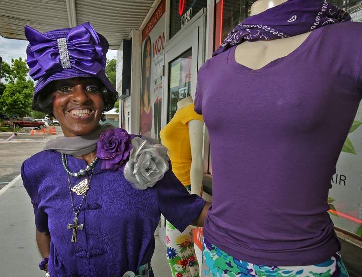 Mildretta Williams of Daytona Beach and a mannequin wear purple in observance of World Lupus Day. She is dressing mannequins to break into the fashion business.  Photo courtesy of the Daytona Beach News-Journal.